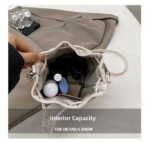 Spacious interior of off-white leather bucket bag showing makeup storage capacity