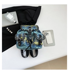Detail of snake print backpack with silver metal rivets and urban fashion lifestyle props
