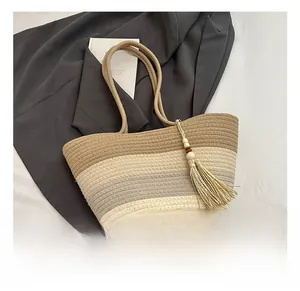 Detail of tricolor woven tote bag featuring soft tassels and intricate texture design