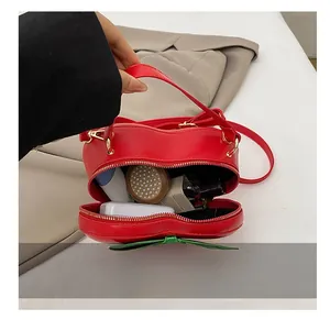 Vue détaillée de la capacité interne du sac à main rouge en forme de fraise pour femme