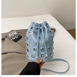Détail du sac seau bleu clair avec œillets métalliques argentés et cordon de serrage
