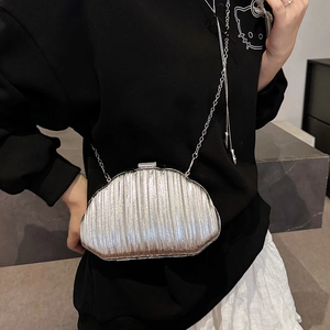Silver shell-shaped clutch bag with metallic pleated texture and chain strap