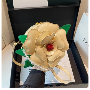 Detailed macro view of cream-white 3D floral crossbody bag with pearl chain in a gift box