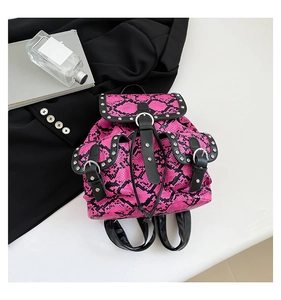 Detail of rose red snakeskin pattern mini backpack with silver rivets and metal buckle