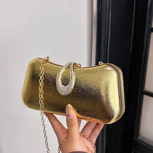 Elegant gold evening clutch bag with textured metallic finish and rhinestone waterdrop lock