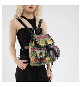 Close-up of vibrant snake print backpack with leather trim and silver metal rivets