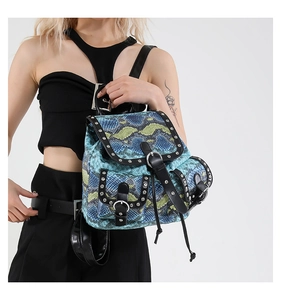 Detail of snake pattern mini backpack with silver rivets and magnetic buckles