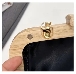 Detail of wooden frame bag with magnetic closure and premium black silk inner lining