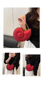 Detailed view of red acrylic conch shell clutch bag with gold chain strap