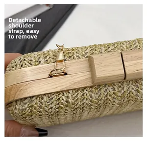Detail of woven bag showing detachable gold chain strap and elegant wooden frame