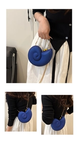 Detail of blue conch shell acrylic evening bag with gold chain and metal handle