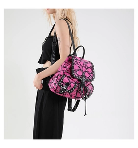 Detail of pink and black snake skin backpack with metallic studs and punk y2k buckles
