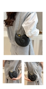 Detailed view of seashell clutch bag with matte black texture and gold chain strap