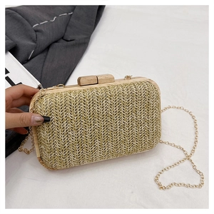 Close-up of woven straw evening clutch with herringbone pattern and wooden frame lock