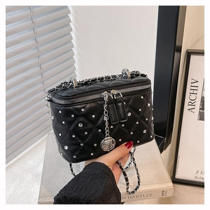 Detail of black quilted leather vanity bag with rhinestones and silver rose zipper pulls