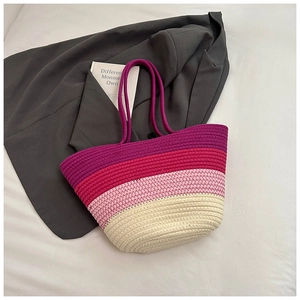 Close-up of four-color gradient woven tote bag with fringe tassels and double handles