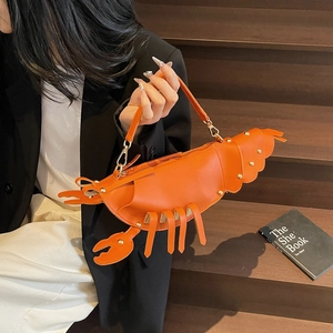 Unique orange lobster-shaped crossbody bag with gold rivets and creative crustacean design