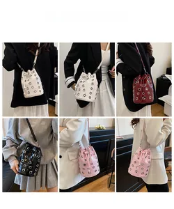 Model display of metallic rivet bucket bags in white, red, black, and pink colors