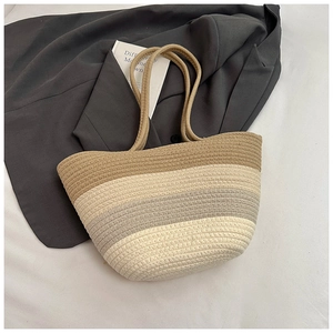 Close-up of tricolor gradient woven tote bag with textured tassels and cotton rope handles