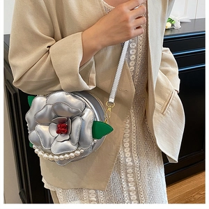 Detailed silver camellia flower crossbody bag with pearl fringes and green leaf accent