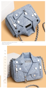 Detail view of denim crossbody bag with motorcycle jacket design and silver hardware