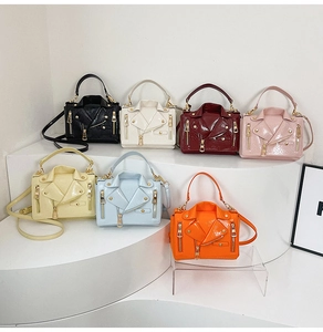 Detail shot of mini biker jacket bags in seven glossy colors with metallic studs