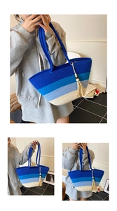 Detail of woven gradient tote bag with blue tassels and textured shoulder strap