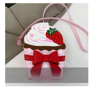 Close-up of strawberry cupcake crossbody bag featuring red bow and white polka dots