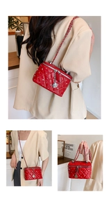 Detail of red quilted leather box bag with pearl accents and silver rose charm