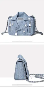 Detail of light blue denim crossbody bag with motorcycle jacket design and silver chain