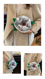 Detail of camellia shaped evening bag with silver petals and pearl trim detail