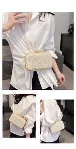 Detail of bohemian straw woven evening bag with wooden frame and golden chain strap