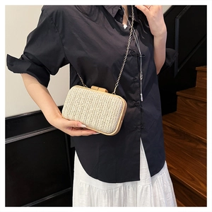 Detail showing handwoven straw texture and vintage wooden frame on a chic evening clutch