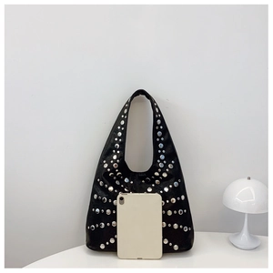 Detail of black tote bag with silver rivets and tablet for size reference