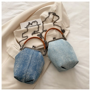 Detail of vintage denim doctor bags with metal studs and bronze handles in two wash colors