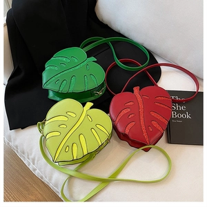 Detailed view of monstera leaf bags with glitter veins in green and red colors