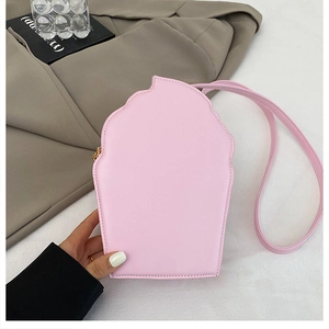 Detail view of pink cupcake crossbody bag featuring matte leather and golden zipper
