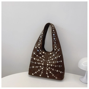 Close-up of vintage brown suede tote bag featuring radial silver rivet decorations