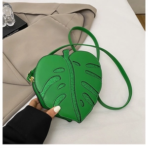 Detail of green leaf-shaped crossbody bag with glitter veins and gold hardware accents