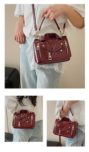 Detail showing Burgundy biker jacket crossbody bag worn as handbag and shoulder bag
