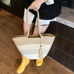 Contrast woven tote bag with fringe charm and long rope handles for casual summer style