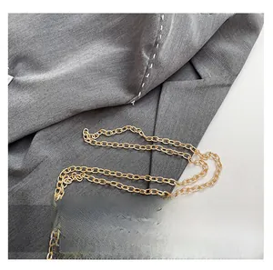 Close-up of a premium gold metal chain strap featuring classic circular link craftsmanship