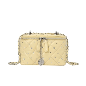 Pale yellow quilted leather crossbody bag with silver crystal accents and camellia charm