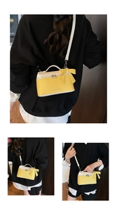 Detail of yellow and white crossbody bag with large bow and litchi texture finish