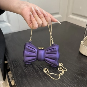 Mini matte lila Schleifen-Tasche mit Goldkette, handgehalten für Größenvergleich