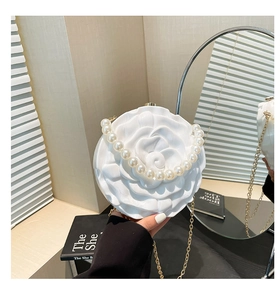 White 3D acrylic rose clutch with large pearl handle and gold chain strap detail