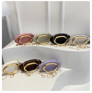 Collection of mini round evening bags in seven colors with gold circular metal handles
