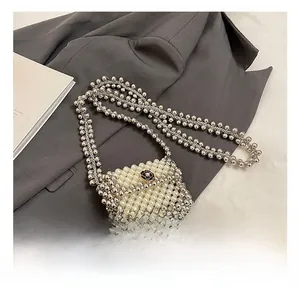 Detail showing the mini woven bead bag with a black and white camellia clasp and pearl chain