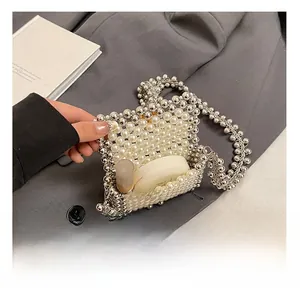 Detailed view of mini pearl beaded bag showing interior space for lipstick and cushion