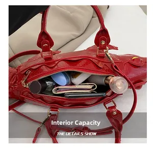 Internal capacity of the crocodile-shaped handbag showing storage for phone and makeup